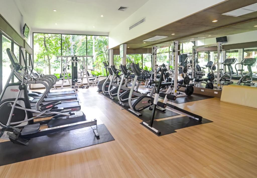 a gym with treadmills and elliptical machines at Katathani Phuket Beach Resort - SHA Extra Plus in Kata Beach
