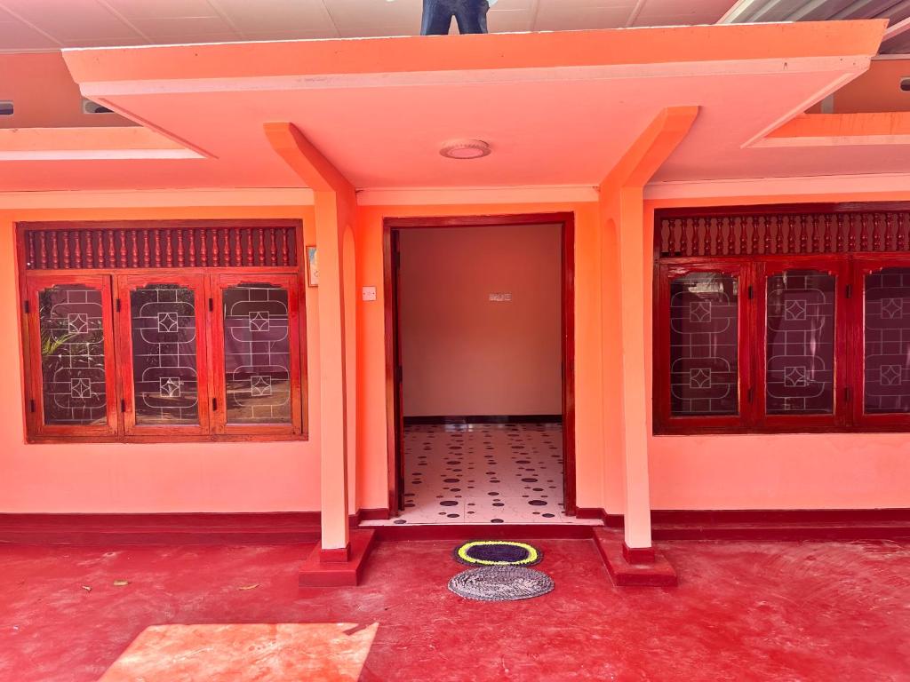an entrance to a building with orange walls at Jaffna Town in Jaffna