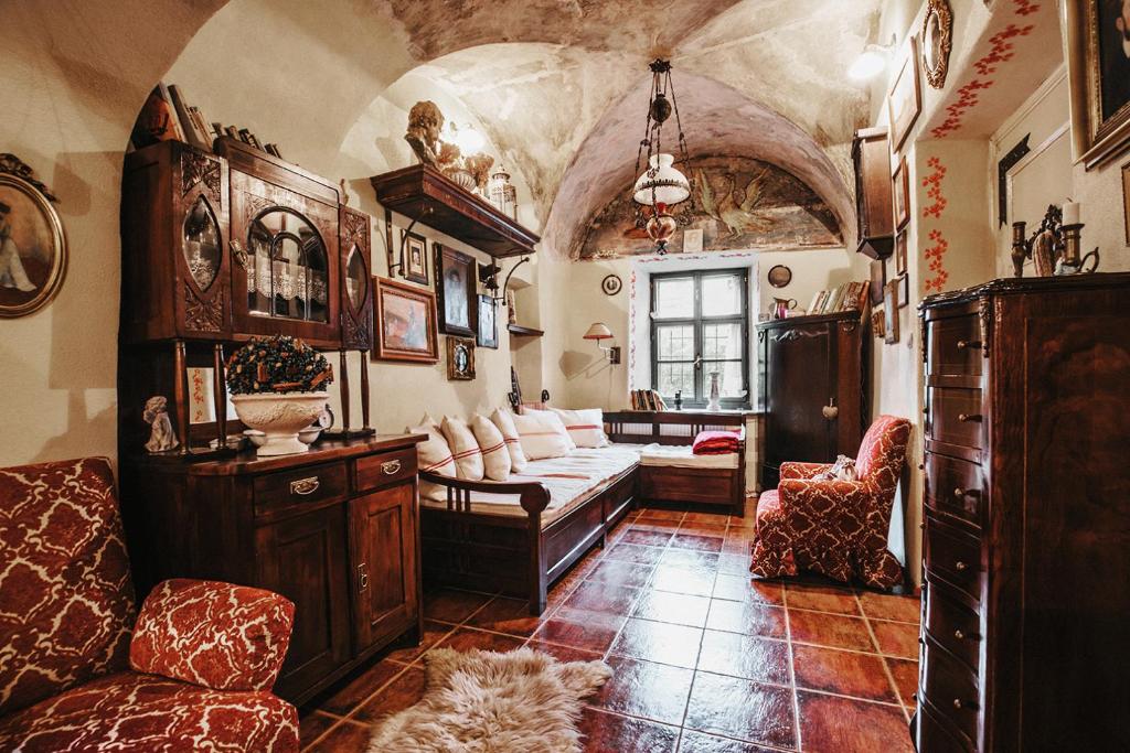 a living room with a couch and a chair at Apartmány na Trojici - DOLNÝ apartmán in Banská Štiavnica