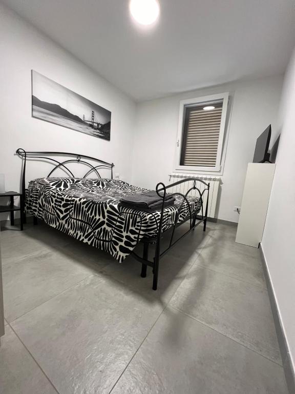 a bedroom with a zebra print bed in a room at San Rocco 30 - camera in campagna - Piombino in Piombino