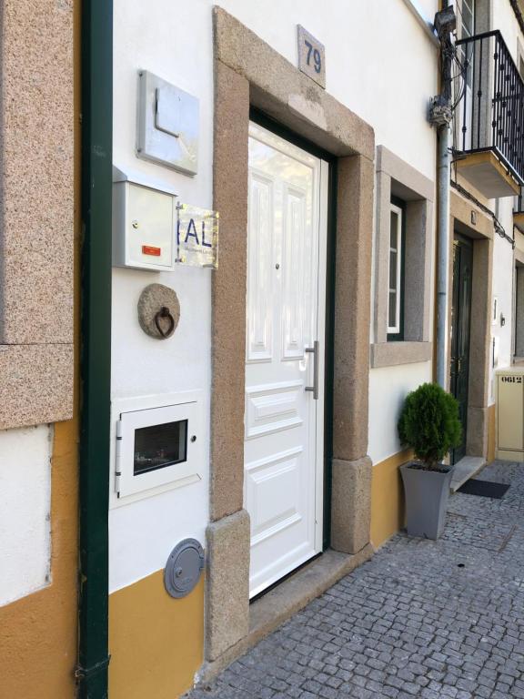 a white door on the side of a building at A Casinha Gomes in Nisa