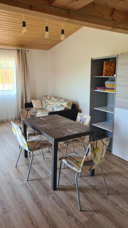 a dining room with a table and two chairs at Orlická přehrada Chata Malá in Kožlí u Orlíka