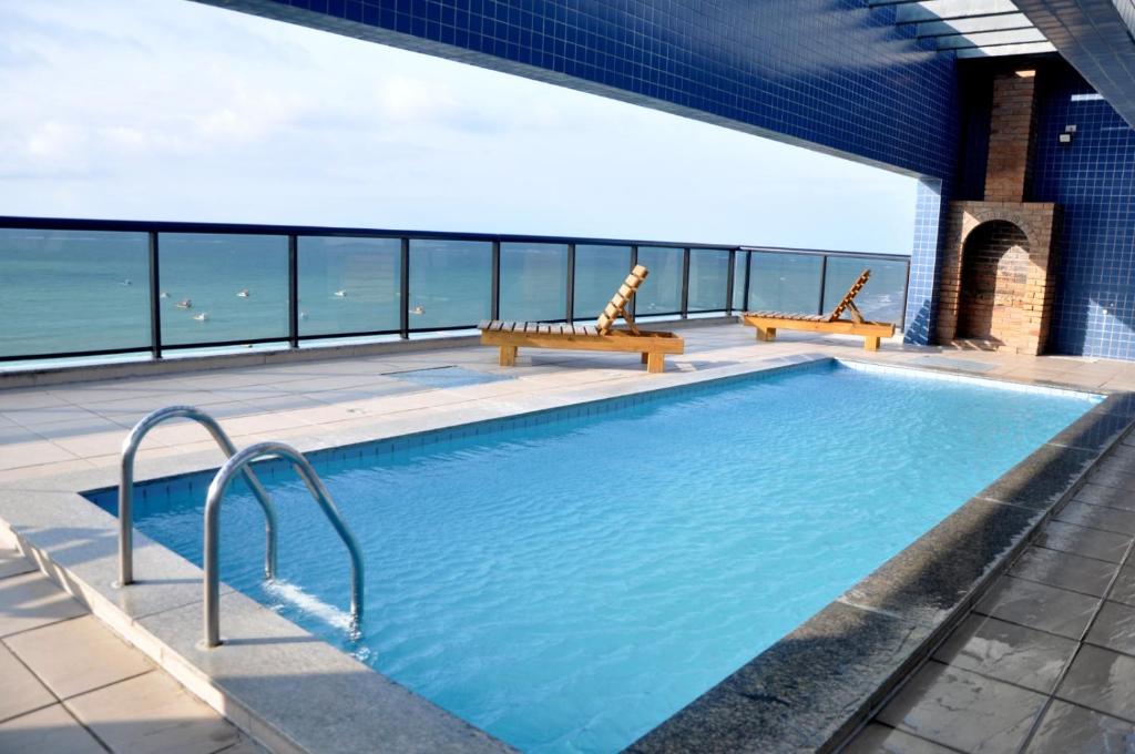 a swimming pool on a building with a view of the ocean at Super Duplex Beira Mar na melhor praia de Maceió-NEO 709 in Maceió