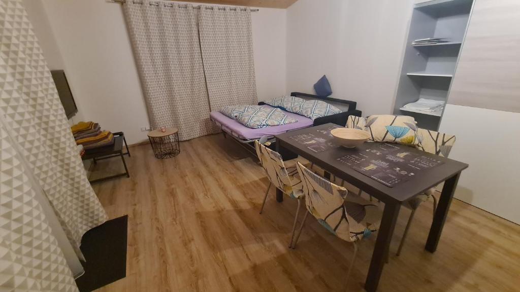 a living room with a table and a couch at Orlická přehrada Chata Malá in Kožlí u Orlíka