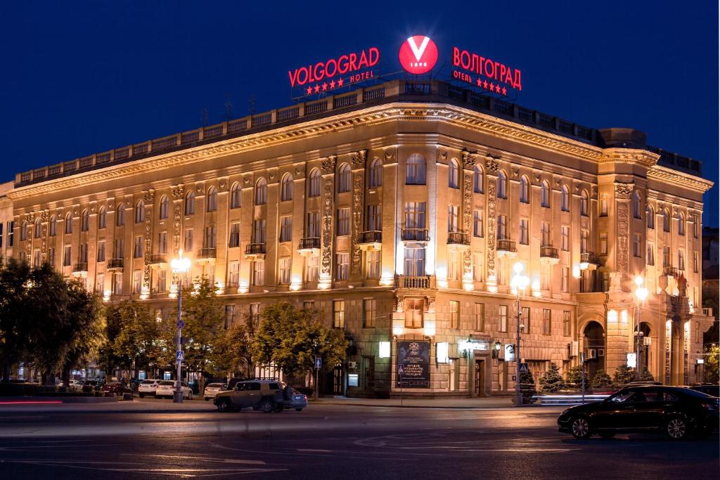 a building with a sign on the top of it at Hotel Volgograd in Volgograd