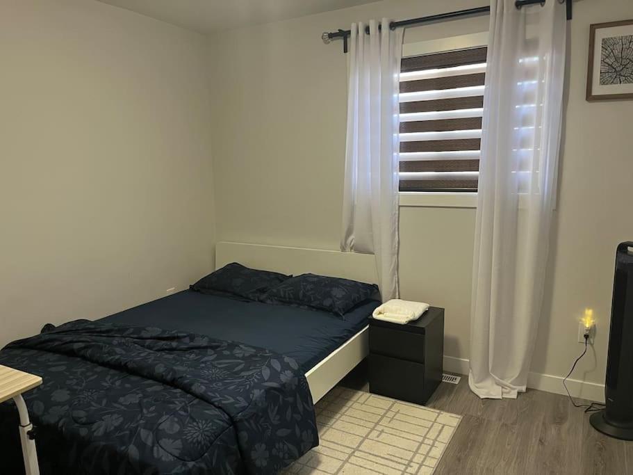 a small bedroom with a bed and a window at Home for yourself in Winnipeg