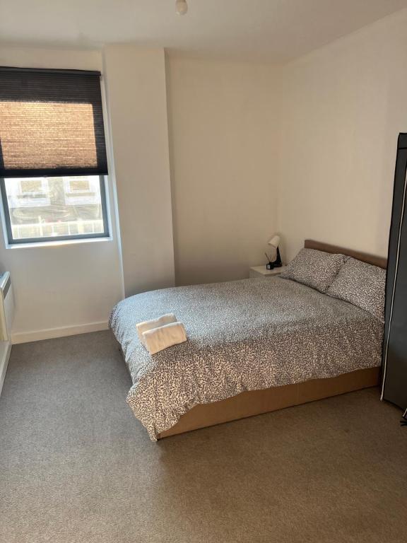 a bedroom with a bed and a window at Modern City Centre Executive Flat in Southend-on-Sea