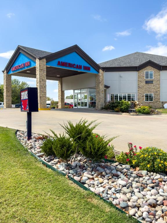 a american inn sign in front of a building at American Inn Madill in Madill
