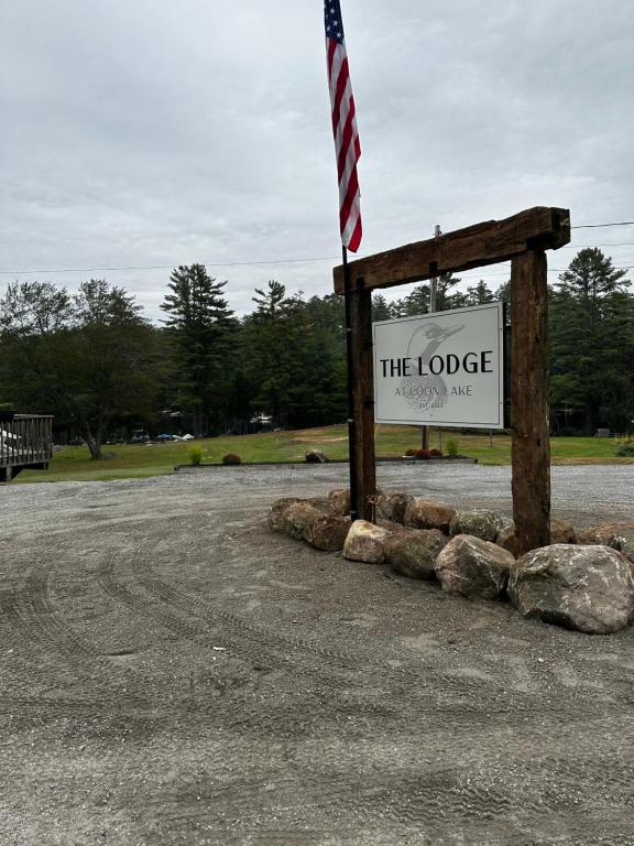 a sign for the lodge with an american flag on it at The Lodge at Loon Lake in Chestertown