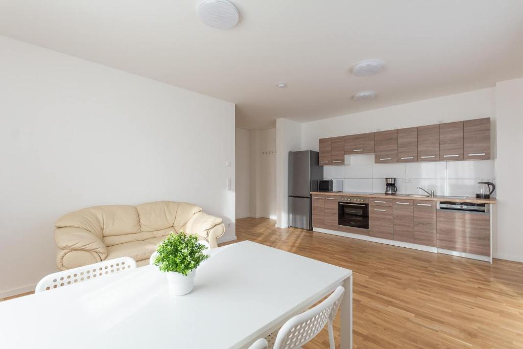 a living room with a white table and a kitchen at T&K Apartments - Bergisch Gladbach - 7 Comfortable Apartments - 20 min to Fair Messe Cologne in Bergisch Gladbach