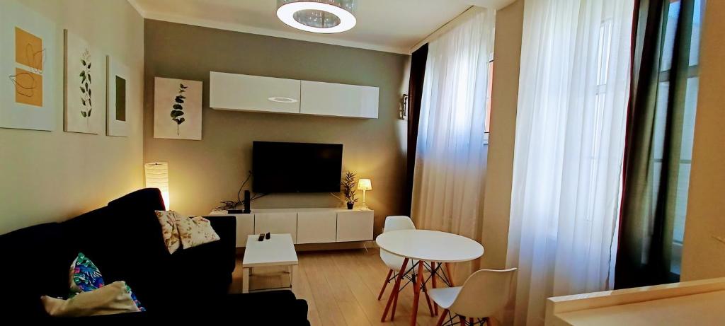 a living room with a couch and a table at Drzewna Apartamenty - Niepodległości in Zielona Góra