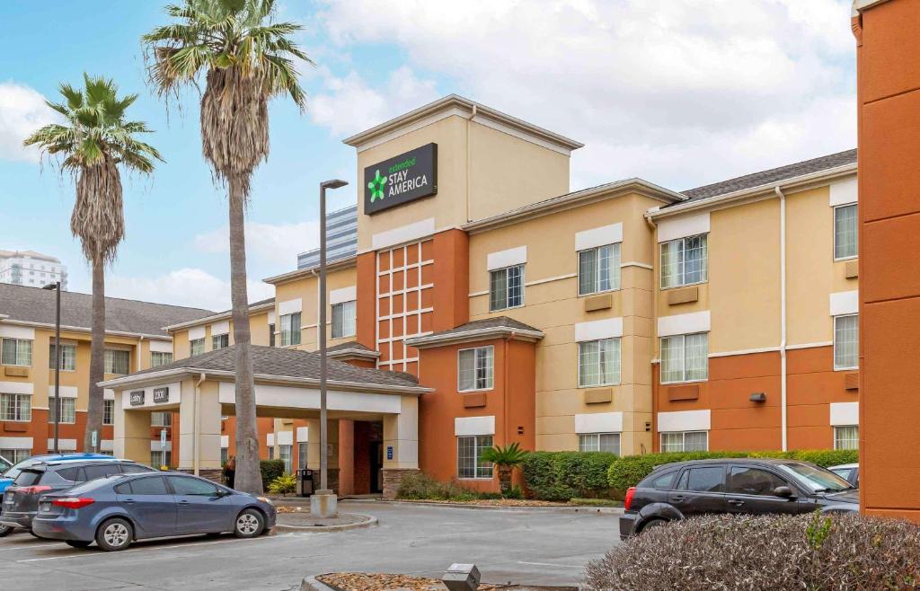 a hotel with cars parked in a parking lot at Extended Stay America Suites - Houston - Galleria - Uptown in Houston
