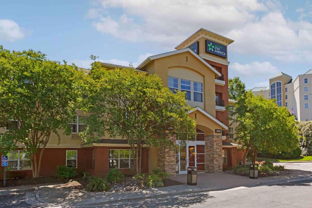 a building with a clock on the top of it at Extended Stay America Suites - Raleigh - RTP - 4919 Miami Blvd in Durham