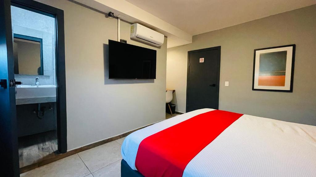 Postel nebo postele na pokoji v ubytování HIT Merida Hotel Boutique