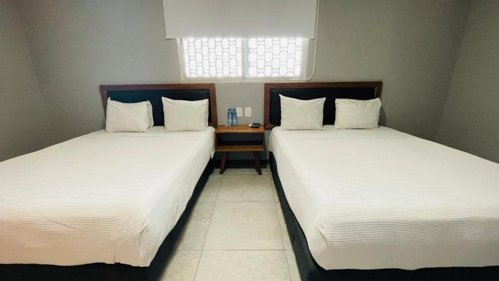Postel nebo postele na pokoji v ubytování HIT Merida Hotel Boutique