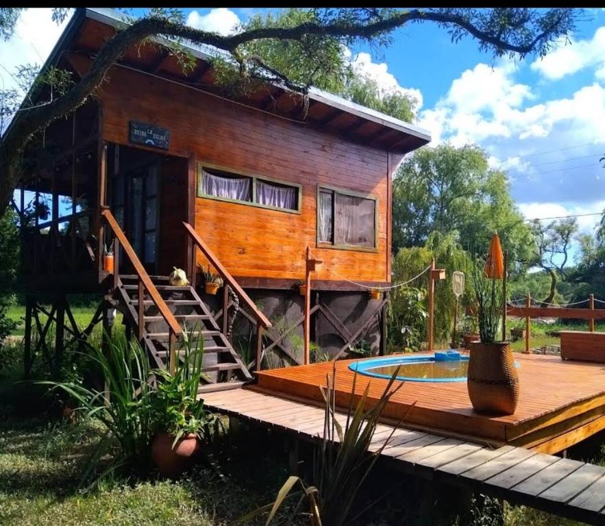a tiny house with a deck and a pool at Krasia May in Tigre