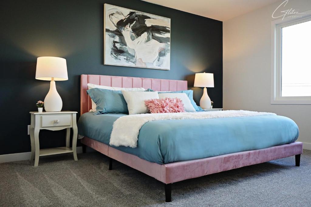 a bedroom with a blue bed with a pink headboard at Beautiful 3 King Beds,Garage,Airport,Disney+ in Edmonton
