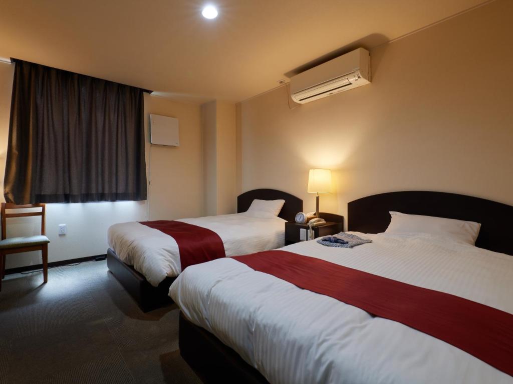 Postel nebo postele na pokoji v ubytování Hotel SIMIZU