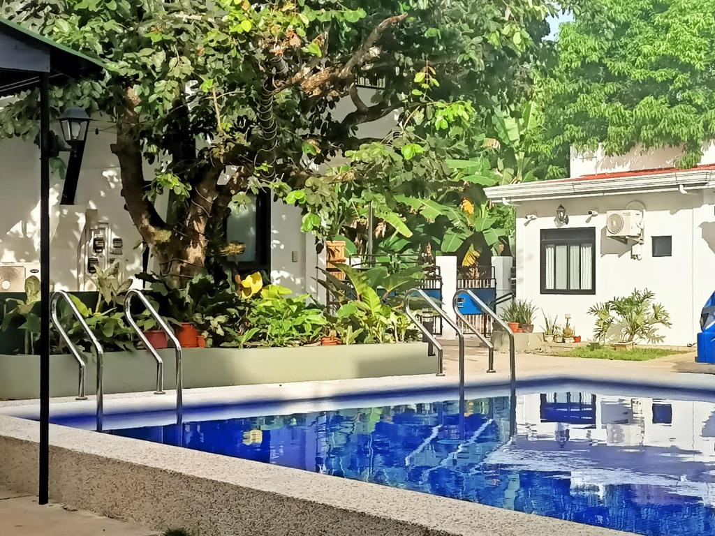 a swimming pool in front of a house at Alona WhiteHouses Resort in Panglao