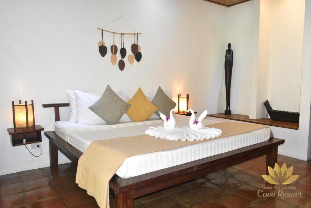 Postel nebo postele na pokoji v ubytování El Nido Coco Resort