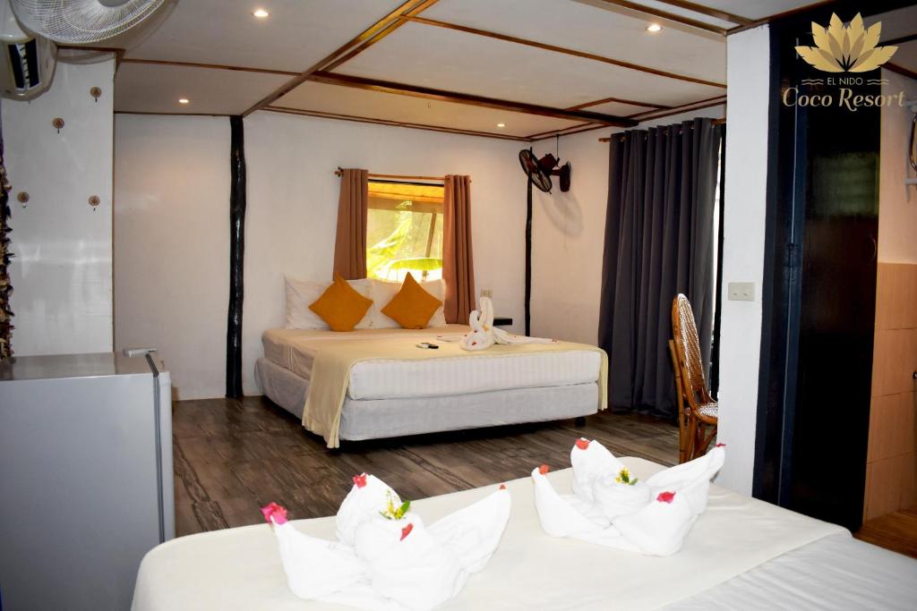 Postel nebo postele na pokoji v ubytování El Nido Coco Resort