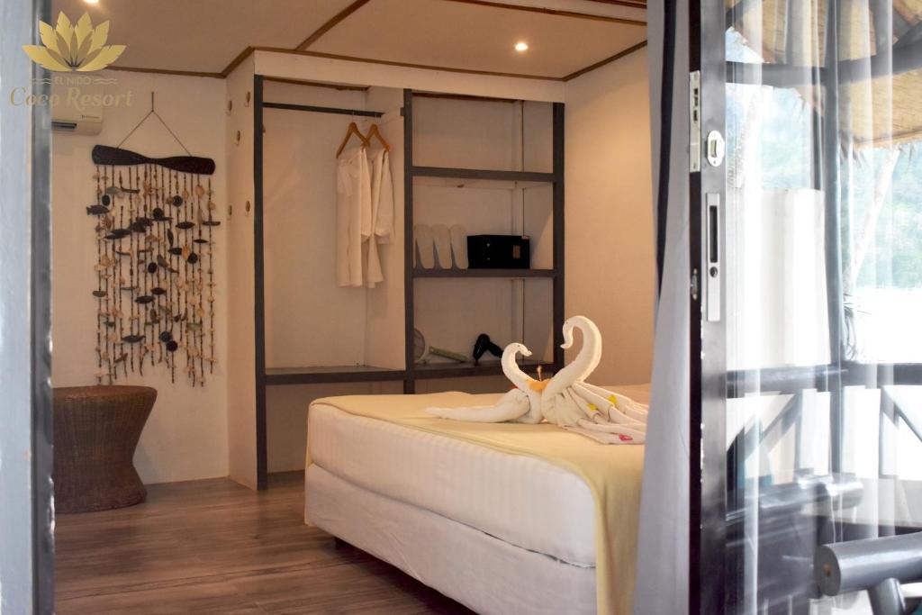 Postel nebo postele na pokoji v ubytování El Nido Coco Resort