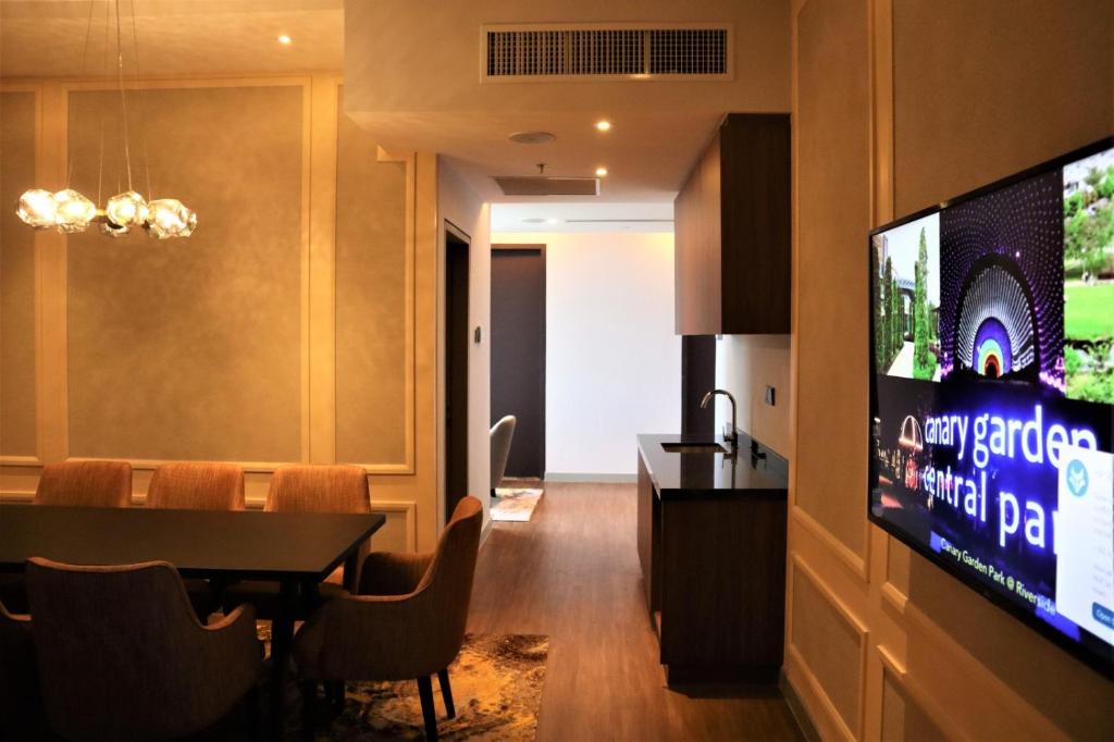 a dining room with a tv and a dining table at KSL ESPLANADE HOTEL with HOT SPRING in Klang