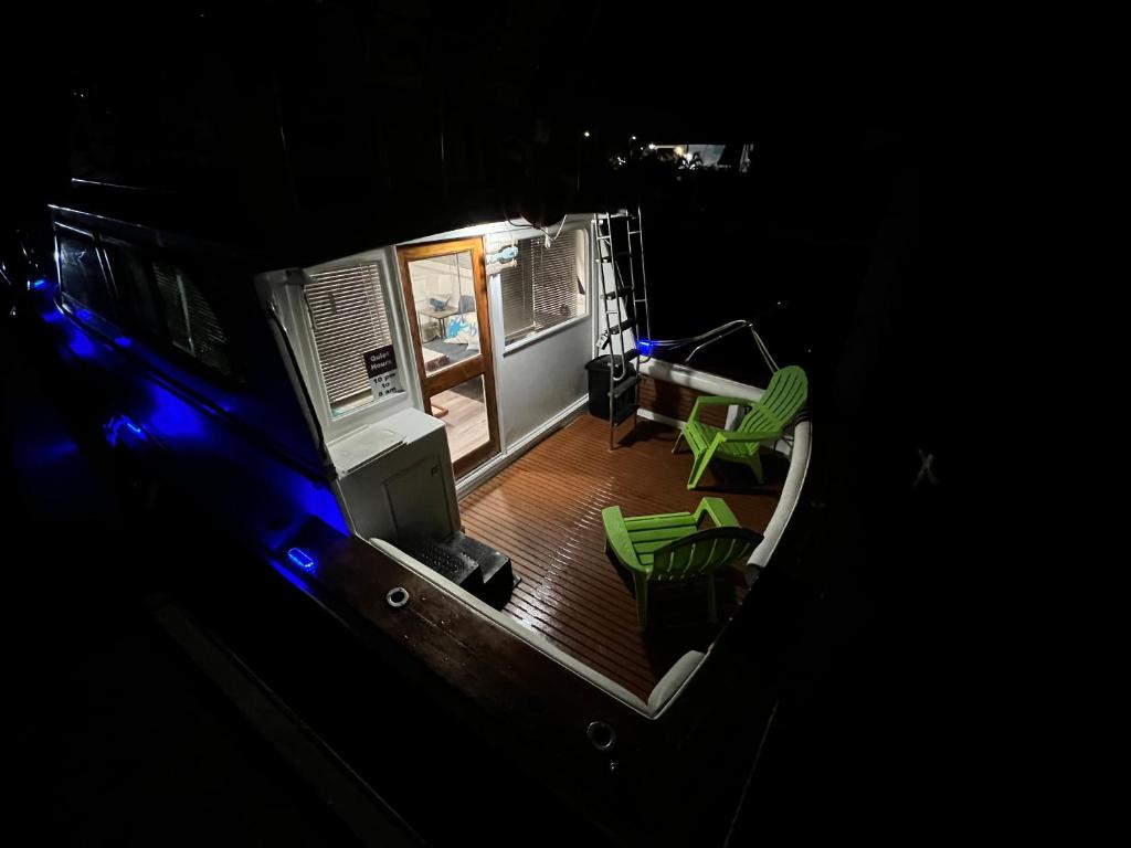 an aerial view of a living room with green chairs at Beautiful Floating Stay in Marathon