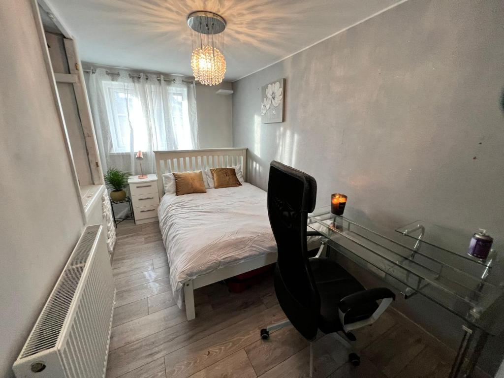 a bedroom with a bed and a desk with a chair at Double room In Corby in Rockingham