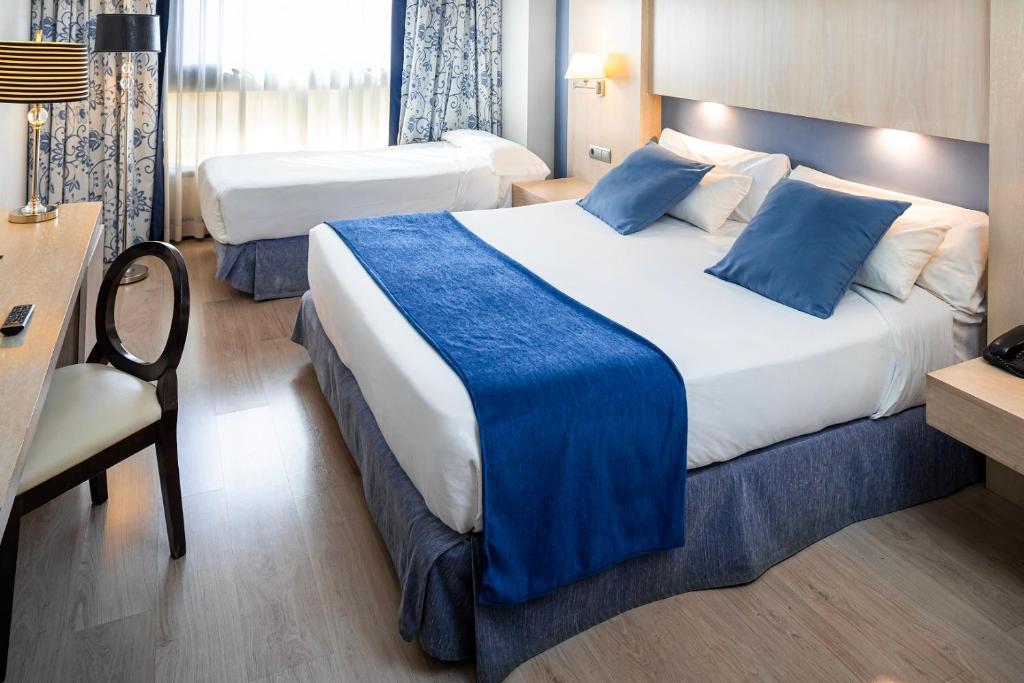 Cama o camas de una habitación en Hotel Nuevo Boston