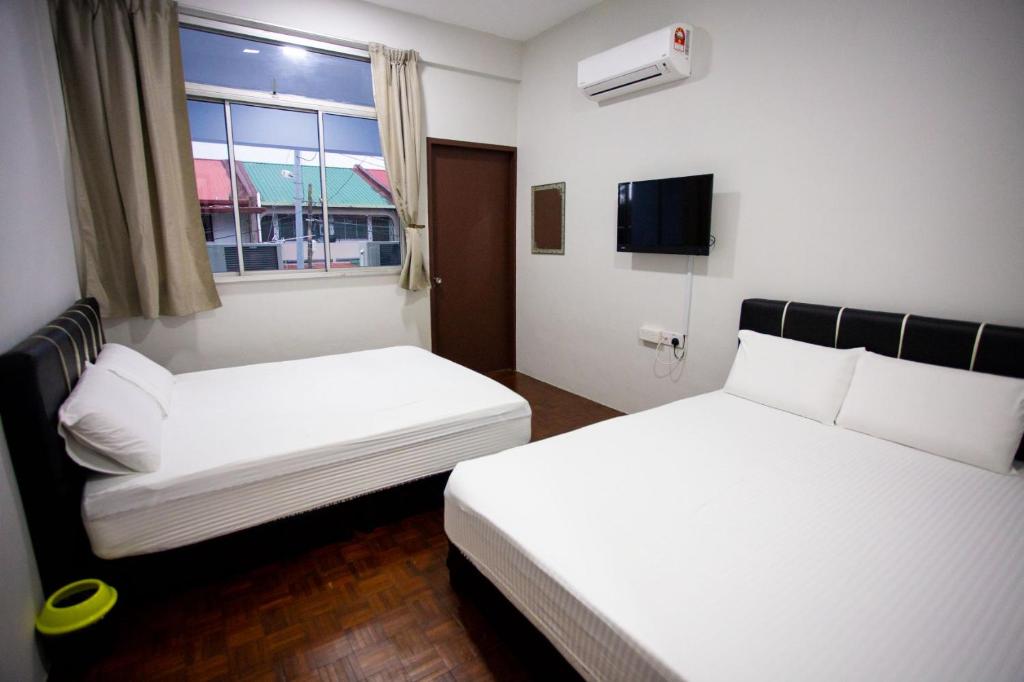 Letto o letti in una camera di Hom2rex Kuching Homestay Taman Timberland