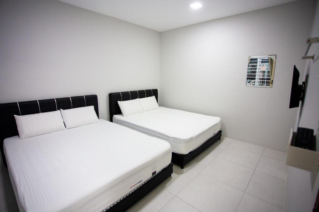 Letto o letti in una camera di Hom2rex Kuching Homestay Taman Timberland