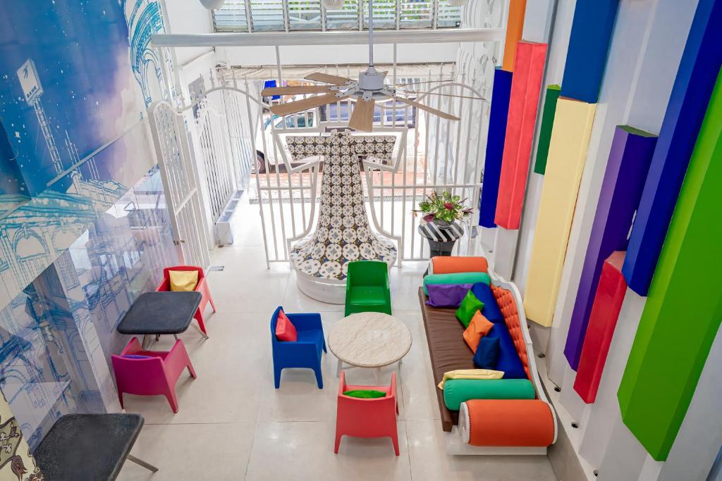 a room with colorful chairs and a table at The Color Kata in Kata Beach