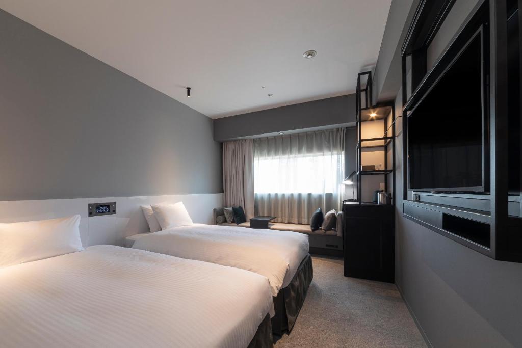 Postel nebo postele na pokoji v ubytování Hotel Keihan Namba Grande