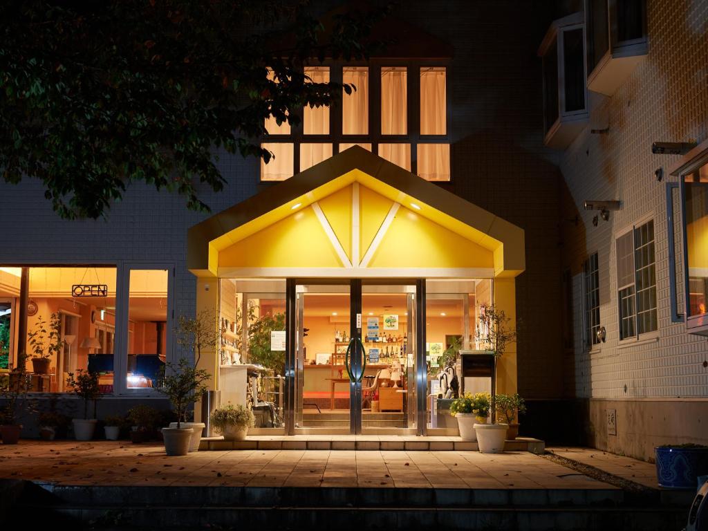 a front door of a building at night at Asama Kogen Hotel in Tsumagoi