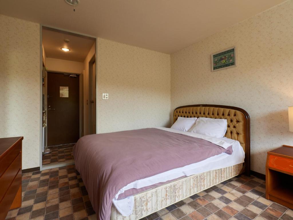 Postel nebo postele na pokoji v ubytování Asama Kogen Hotel