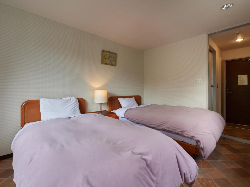 Postel nebo postele na pokoji v ubytování Asama Kogen Hotel