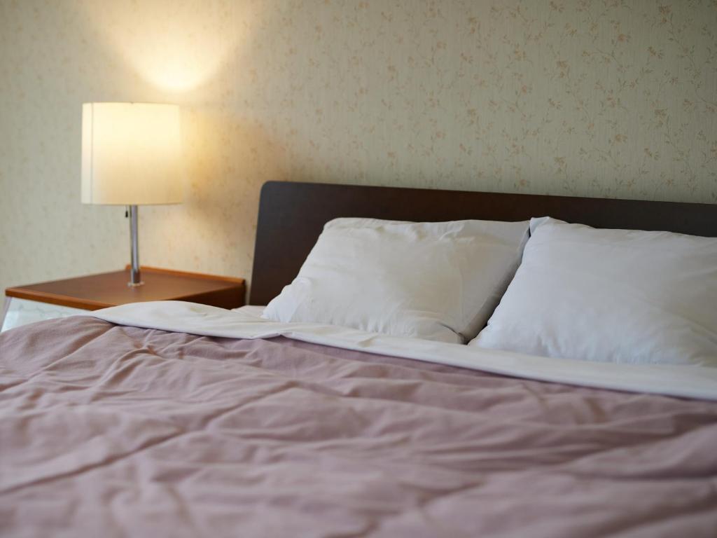 Postel nebo postele na pokoji v ubytování Asama Kogen Hotel