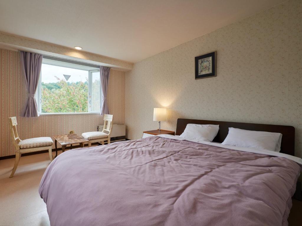 Postel nebo postele na pokoji v ubytování Asama Kogen Hotel