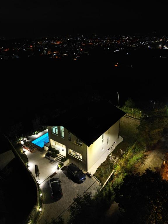 a building with a parking lot at night at Villa 22 in Tirana