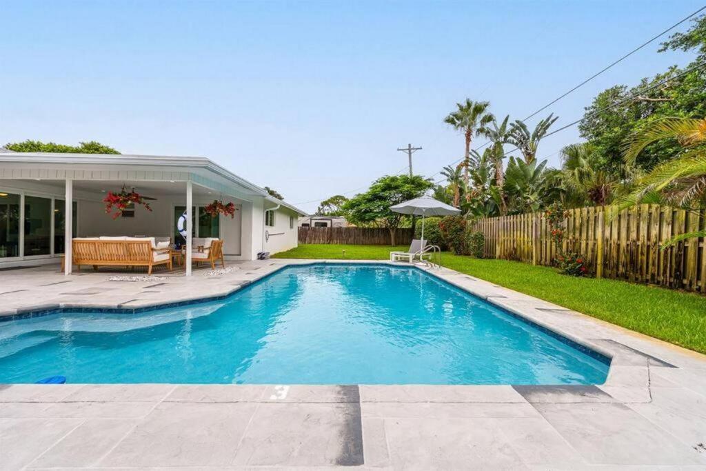 a swimming pool in the backyard of a house at Luxury Designer Delray Beach. 10 Min to the Beach! in Delray Beach