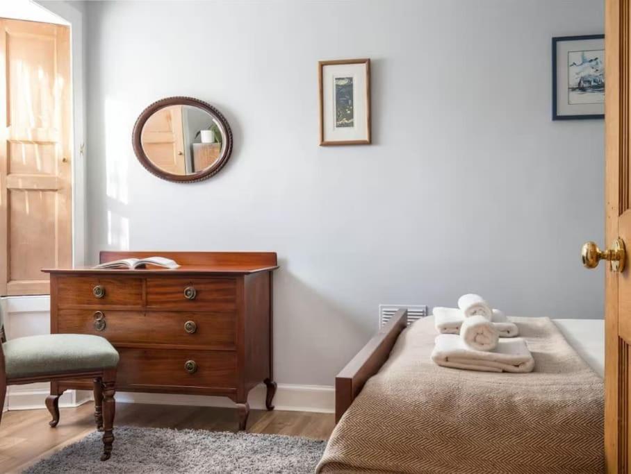 - une chambre avec un lit, une commode et un miroir dans l'établissement The Third, à Édimbourg