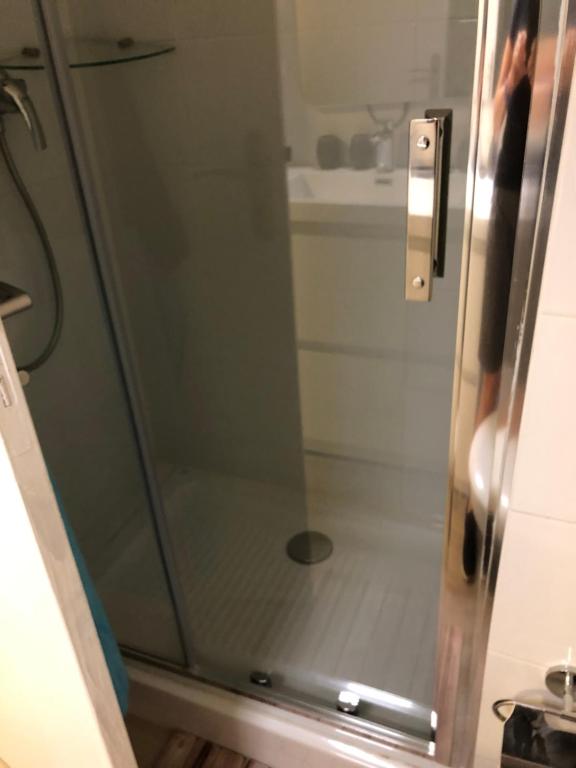 a shower with a glass door in a bathroom at Soleil 2023 in Antibes