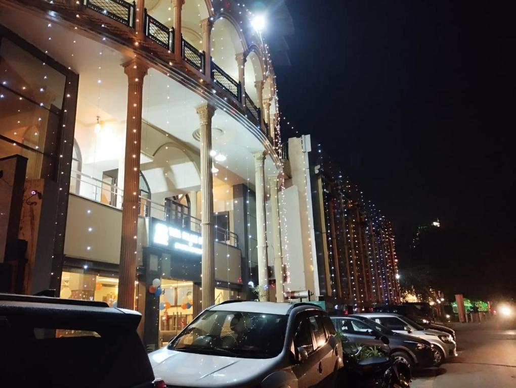a car parked in front of a building at night at Hotel Tara Palace by Goyal Hoteliers in Agra