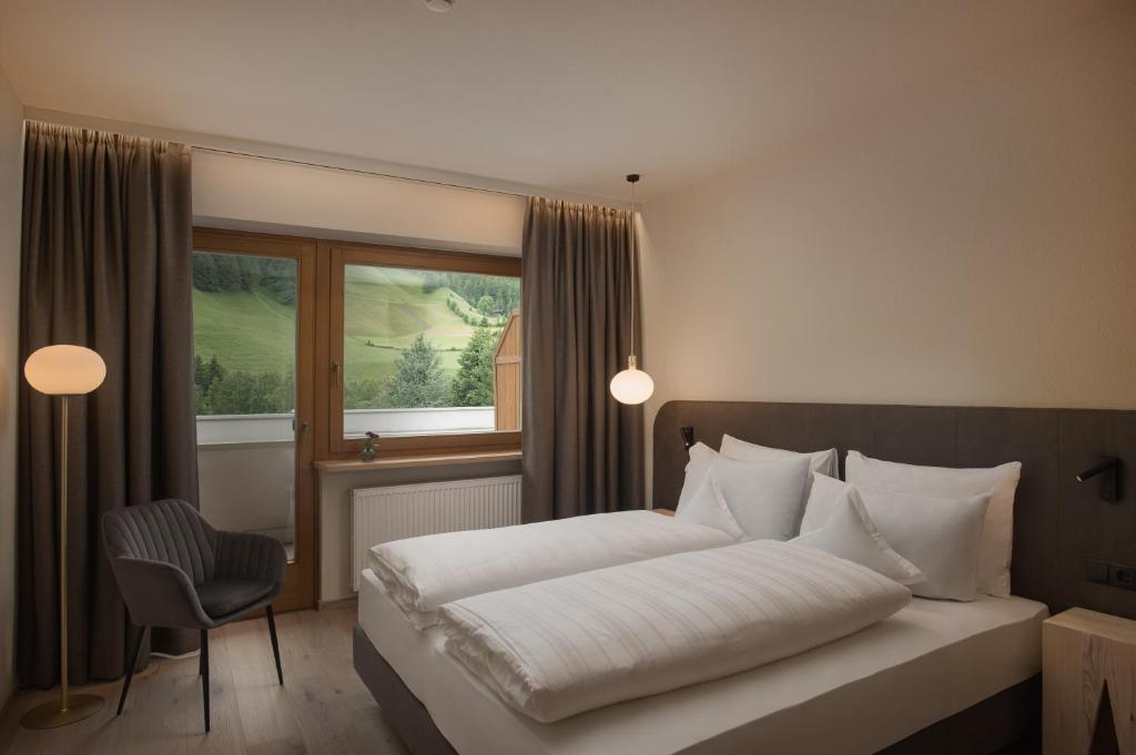 Postel nebo postele na pokoji v ubytování Naturhotel MOLIN