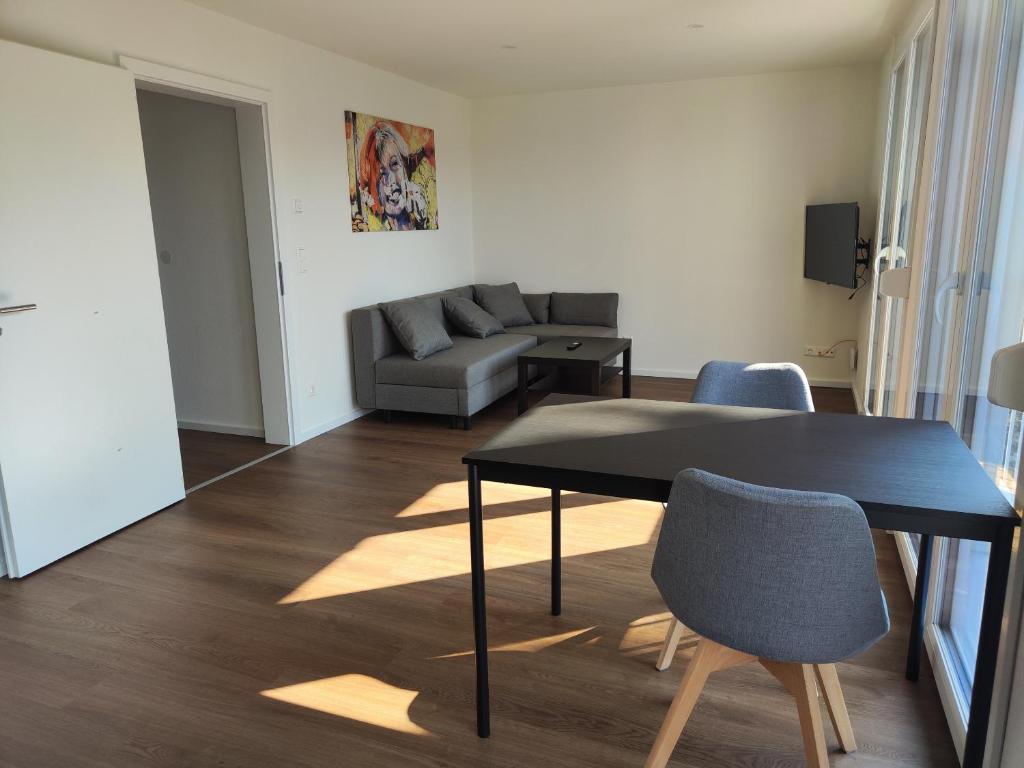a living room with a table and a couch at Apartmenthaus Pforzheim in Pforzheim