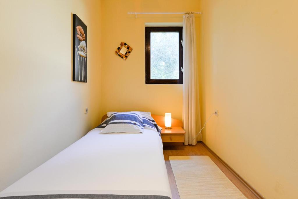 Łóżko lub łóżka w pokoju w obiekcie Apartments Doda