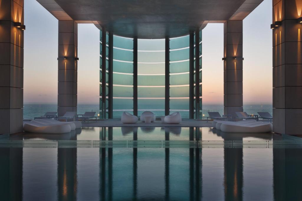 a hotel swimming pool with a view of a building at Royal Beach Hotel Tel Aviv by Isrotel Exclusive in Tel Aviv