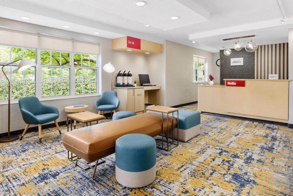 a waiting room with a couch and blue chairs at TownePlace Suites Philadelphia Horsham in Horsham