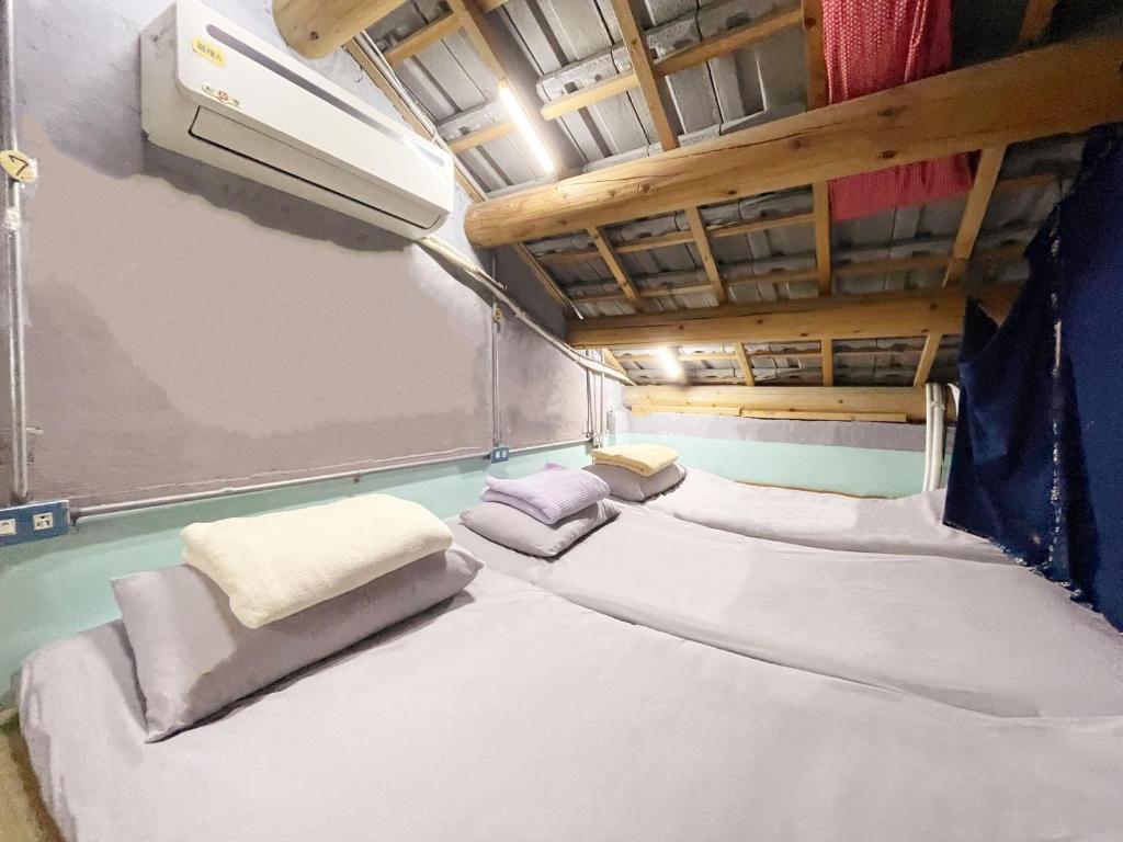 Postel nebo postele na pokoji v ubytování Fuqi Hostel - Heping